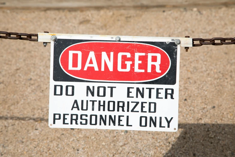 a sign that says danger don't enter authorized personnel only, by Bob Thompson, pexels, 2000s photo, land mines, teenage no, 1990's photo