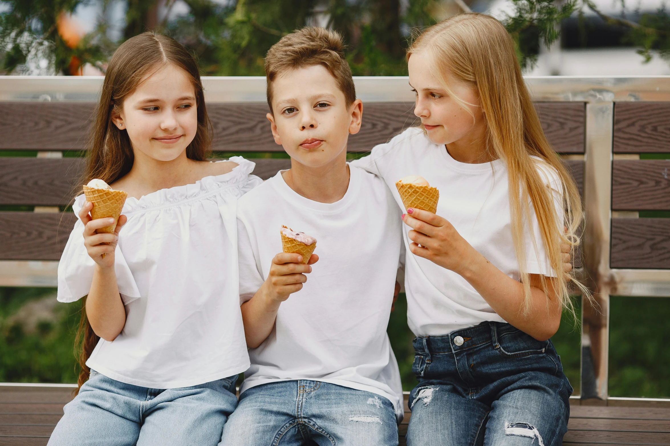 three children sitting on a bench eating donuts, pexels, ice cream cones, wearing a t-shirt, dasha taran, white