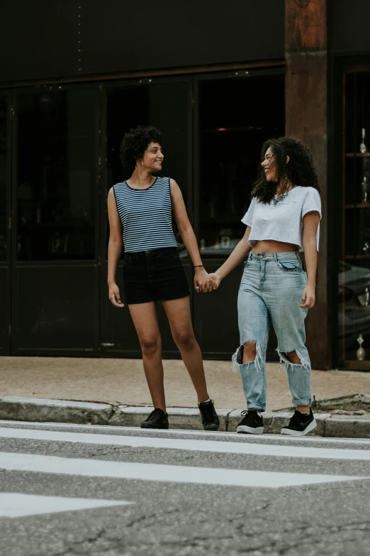 two women walking down the street holding hands, trending on pexels, renaissance, boy shorts, non binary model, teenage, latinas