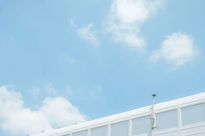 a man riding a snowboard on top of a snow covered slope, an album cover, unsplash, postminimalism, monorail station, blue sky with a few clouds, set in tokyo rooftop, minimalist photo