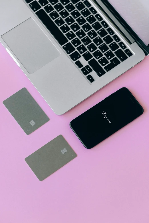 a laptop computer sitting on top of a pink table, cards, detailed product image, three, - 9