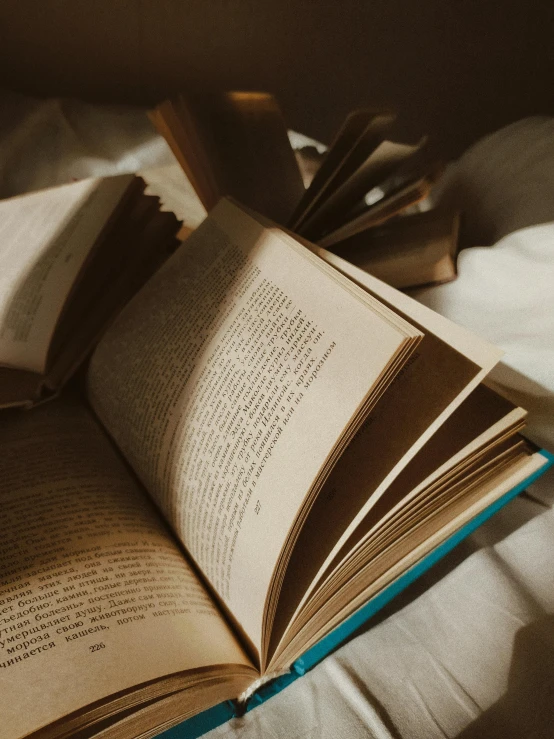 an open book sitting on top of a bed, pexels contest winner, happening, rim lit, thumbnail, unedited, library books