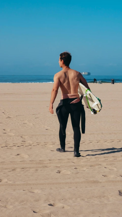 a man walking on a beach holding a surfboard, with his back turned, profile image, taejune kim, 6 pack
