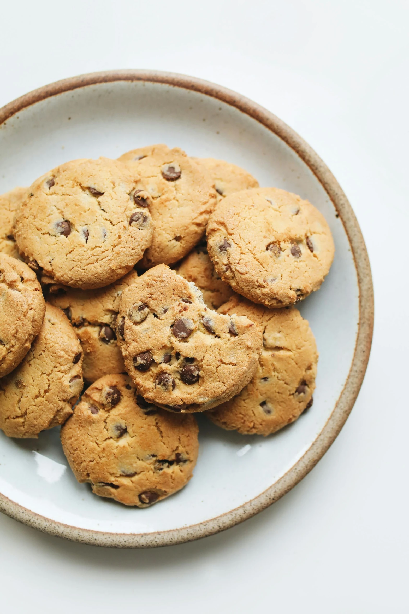 a plate of chocolate chip cookies on a table, unsplash, modernism, jen atkin, panoramic, high resolution product photo, mint