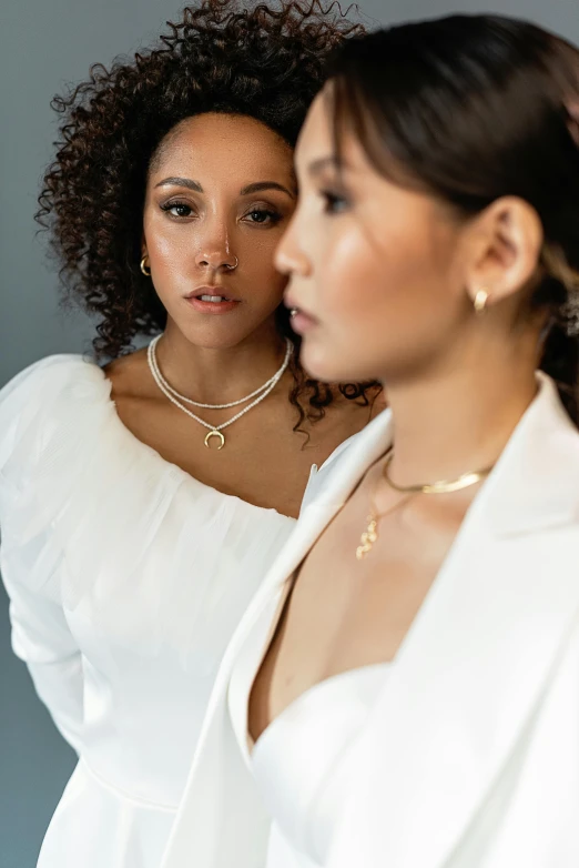 two women standing next to each other in front of a mirror, inspired by Louis Le Nain, renaissance, platinum jewellery, neck rings, nathalie emmanuel, ethereal gold and silver tones