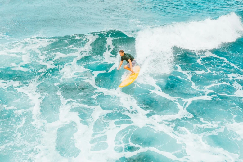 a man riding a wave on top of a yellow surfboard, pexels contest winner, australian beach, clean 4 k, instagram post, 1 2 9 7