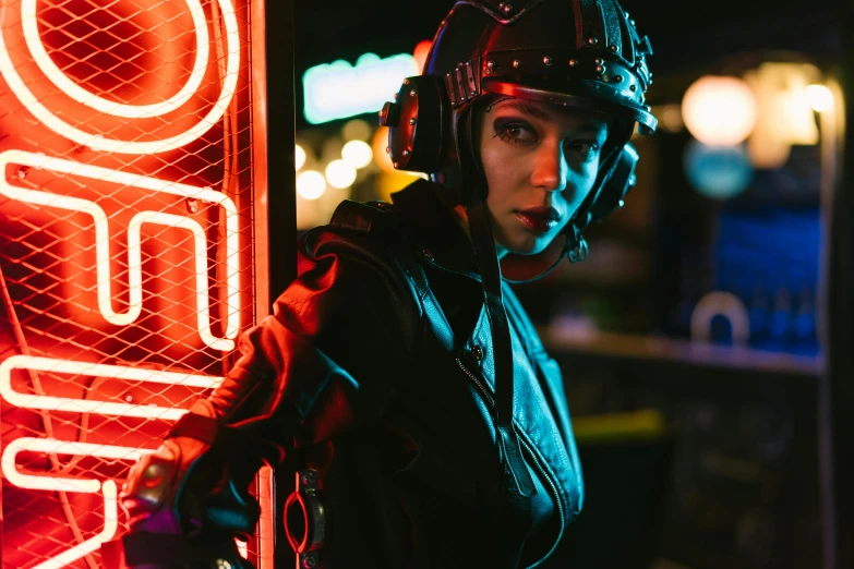 a woman wearing a helmet standing in front of a neon sign, cyberpunk art, inspired by Elsa Bleda, pexels contest winner, leather pilots uniform, attractive girl, riding, instagram post