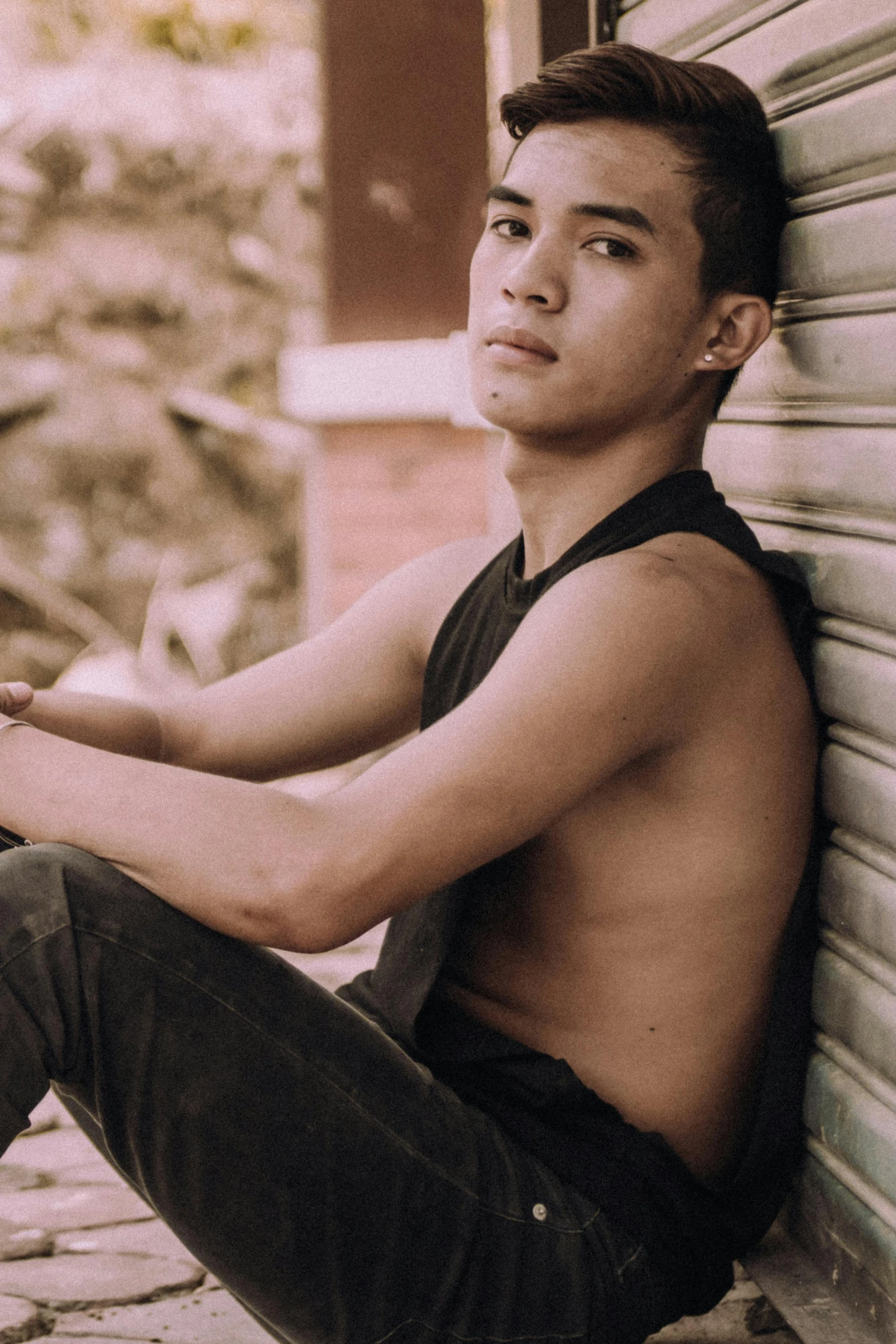 a shirtless young man sitting against a wall, an album cover, inspired by Byron Galvez, unsplash, wearing tank top, profile pic, lgbtq, asian male