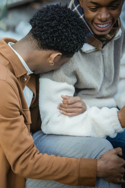 a man sitting next to a woman holding a baby, trending on pexels, renaissance, grieving, wearing jacket, wearing a white sweater, holding each other hands