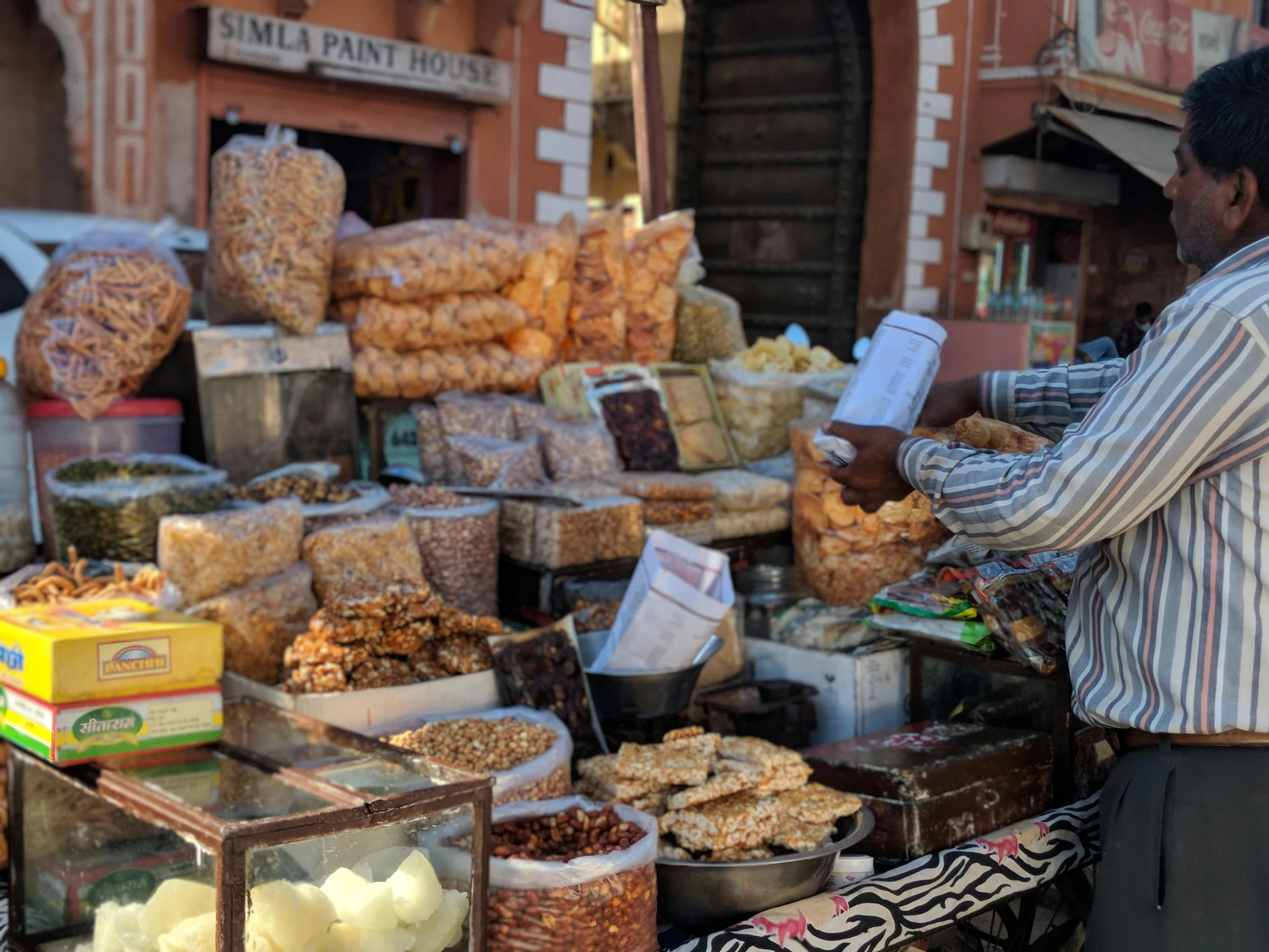 a man standing in front of a display of food, marrakech, fan favorite, square, image