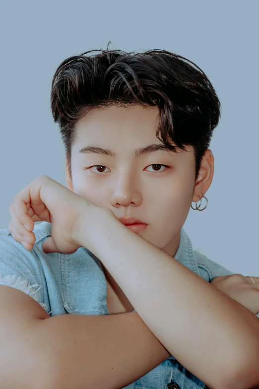 a man sitting at a table with his hand on his chin, an album cover, inspired by Kim Myeong-guk, trending on pexels, androgynous face, short horns, headshot profile picture, little boy