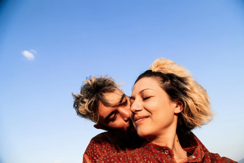 a man and a woman standing next to each other, trending on pexels, happening, blue and clear sky, lesbian embrace, mina petrovic, licking out