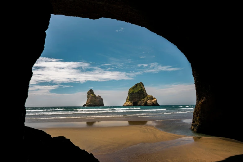 a view of the ocean from inside a cave, by Peter Churcher, pexels contest winner, renaissance, maori, majestic spires, beach landscape, high resolution photo