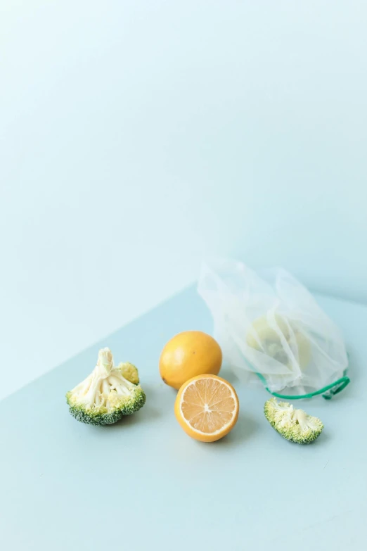 broccoli, lemons, and a plastic bag on a table, unsplash, on a pale background, detailed product image, pouches, n-4