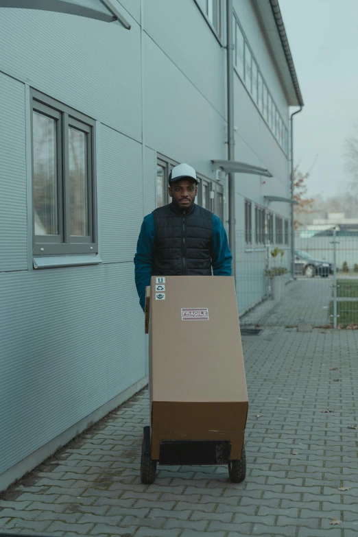 a man pushing a cart with a box on it, by Sebastian Spreng, 8 k film still, ( ( dark skin ) ), delivering mail, wearing a plug suit