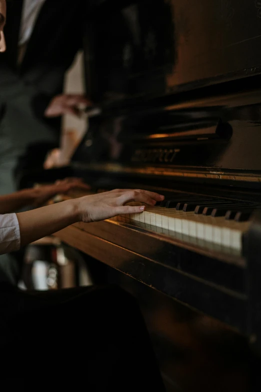 a close up of a person playing a piano