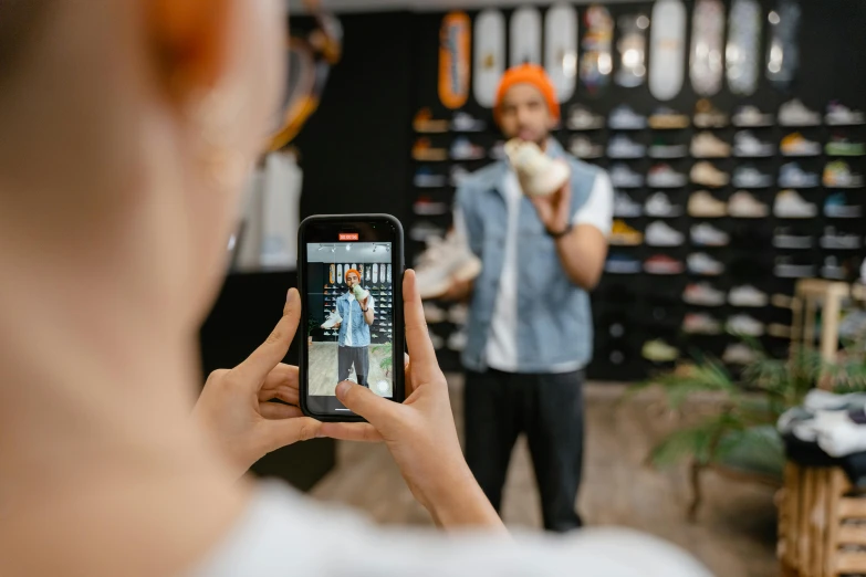 a woman taking a picture of a man in a shoe store, trending on pexels, standing on a skateboard, avatar image, professional iphone photo, outlive streetwear collection