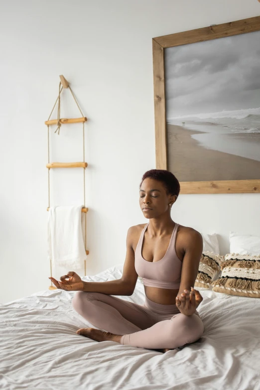 a woman sitting in a yoga position on a bed, a portrait, trending on pexels, renaissance, low quality photo, hard breathing, inviting posture, focused photo