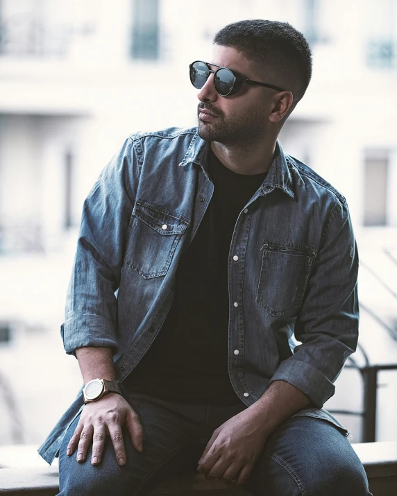 a man sitting on top of a wooden bench, an album cover, inspired by Michael Ray Charles, pexels contest winner, hurufiyya, wearing double denim, reza afshar, wear ray - ban glass, profile image