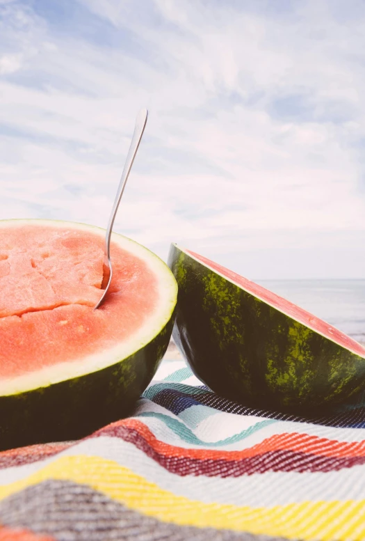 a couple of slices of watermelon sitting on top of a blanket, unsplash, beach setting medium shot, multiple stories, slide show, sunfaded