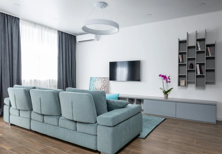 a living room filled with furniture and a flat screen tv, unsplash contest winner, light and space, pale cyan and grey fabric, air conditioner, high quality photo, simple ceiling
