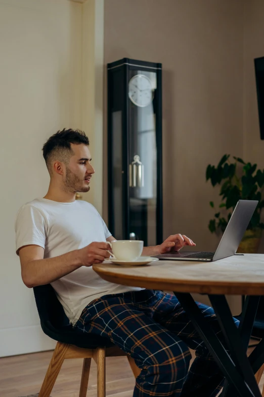 a man sitting at a table with a laptop, with a white mug, style of seb mckinnon, kacper niepokolczycki, highly upvoted
