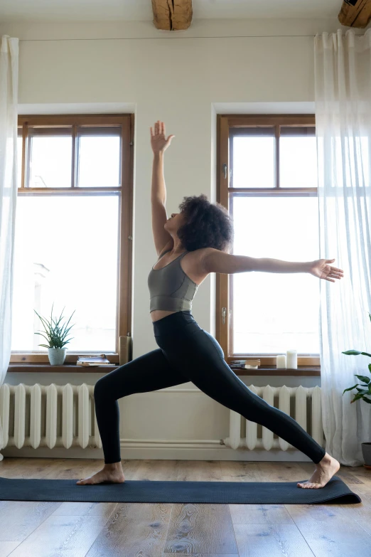 a woman doing a yoga pose in front of a window, pexels contest winner, arabesque, dynamic active running pose, low quality photo, leaked image, tall