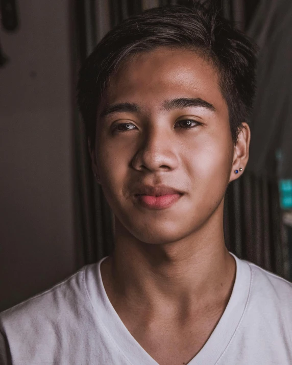 a close up of a person wearing a white shirt, a character portrait, inspired by Ryan Yee, trending on unsplash, sumatraism, lgbt, cute young man, desaturated, peruvian looking