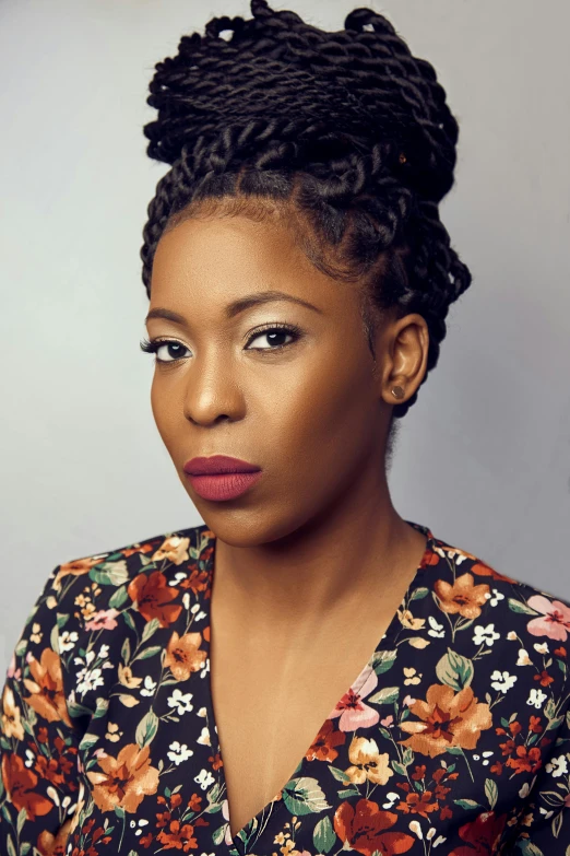 a woman in a floral shirt posing for a picture, by Lily Delissa Joseph, acting headshot, box braids, dark. no text, promo photo