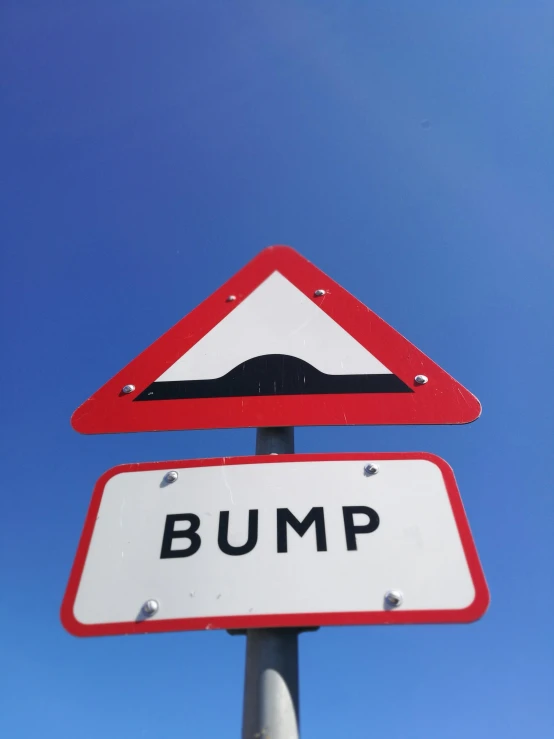 a close up of a street sign with a blue sky in the background, an album cover, by Rupert Shephard, happening, bump map, bumps, ramps, found on a volcano