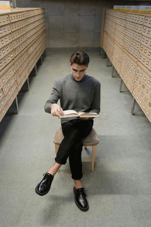 a man sitting on a bench reading a book, inspired by Constantin Hansen, curated collections, stood in a lab, androgynous male, in rows