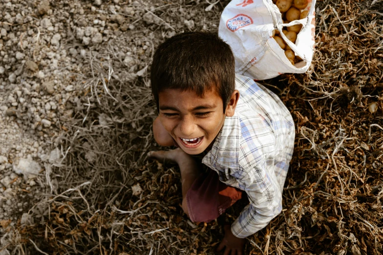 a little boy that is standing in the dirt, pexels contest winner, hurufiyya, smiling down from above, potato, from slumdog millionaire, 15081959 21121991 01012000 4k