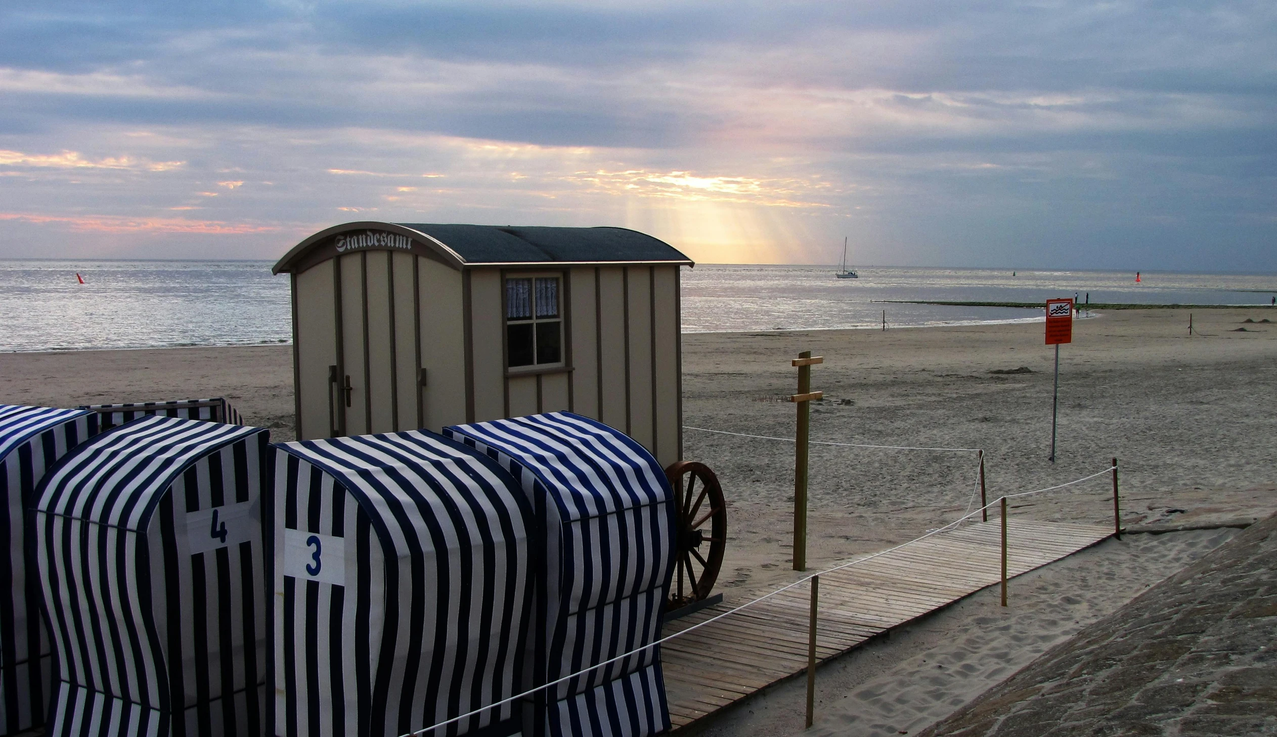 a couple of beach huts sitting on top of a sandy beach, by Jan Tengnagel, pixabay contest winner, art nouveau, toilet, carriage, humid evening, square