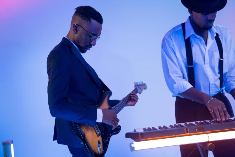 two men standing next to each other playing musical instruments, inspired by Gerard Sekoto, profile image, keyboardist, playing electric guitar, commercial photograph