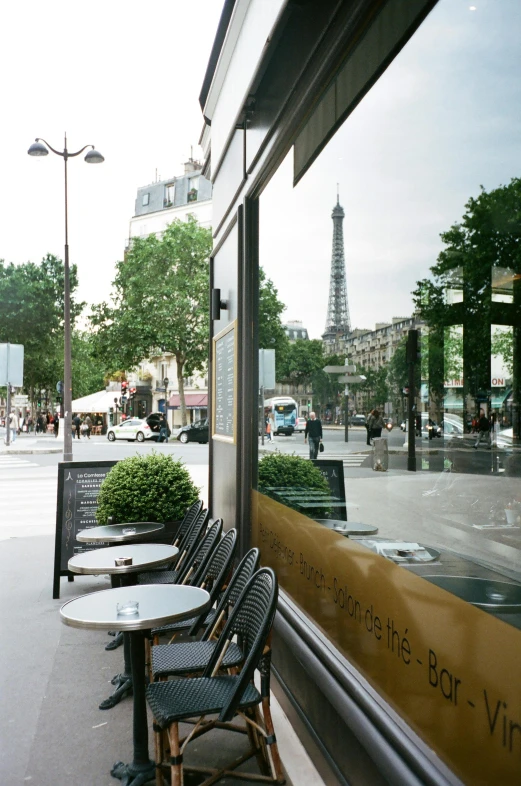 a row of chairs sitting in front of a window, a photo, trending on unsplash, paris school, fresh bakeries in the background, glass obelisks, ignant, in a sidewalk cafe