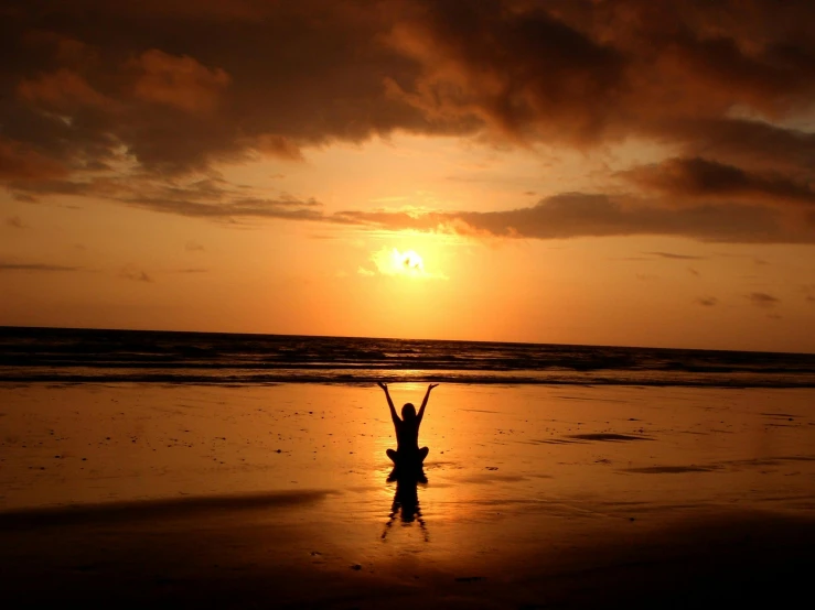 a person doing a handstand on a beach at sunset, by Maggie Hamilton, pexels contest winner, praying meditating, with arms up, bali, scientific photo