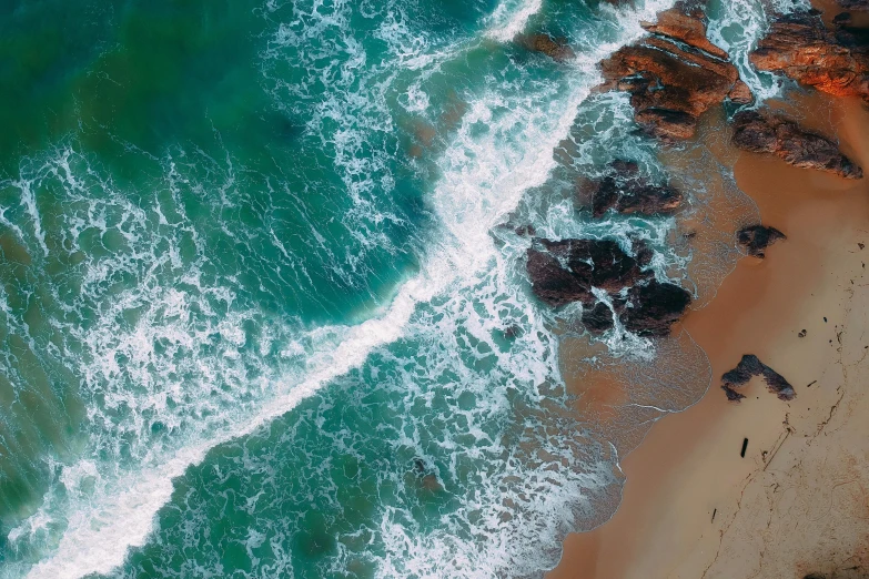 a large body of water next to a sandy beach, pexels contest winner, cresting waves and seafoam, bird view, ocean sprites, “ iron bark