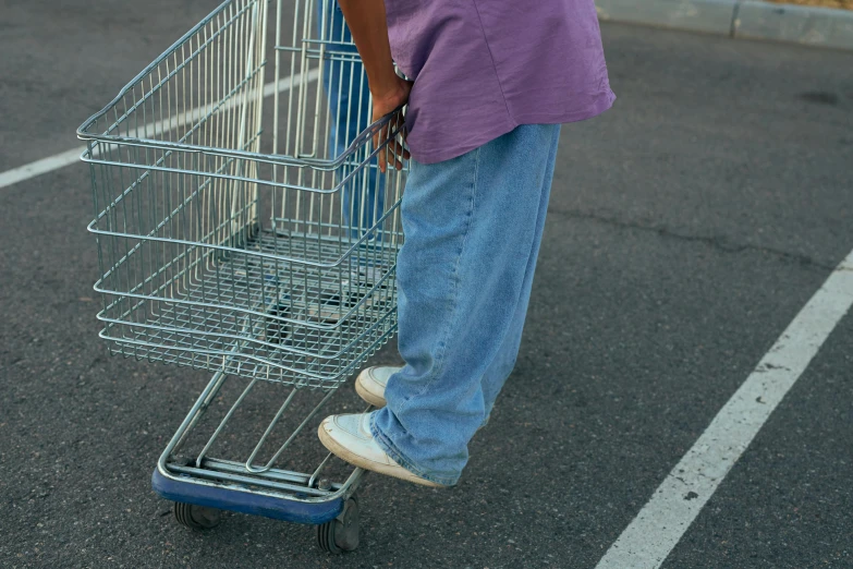 a person pushing a shopping cart in a parking lot, by Everett Warner, pexels, hyperrealism, baggy jeans, purple, scrubs, 1 9 9 0 s style