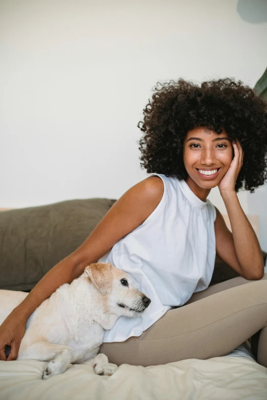 a woman sitting on a couch with a dog, pexels contest winner, renaissance, natural hair, an all white human, smiling young woman, mixed race