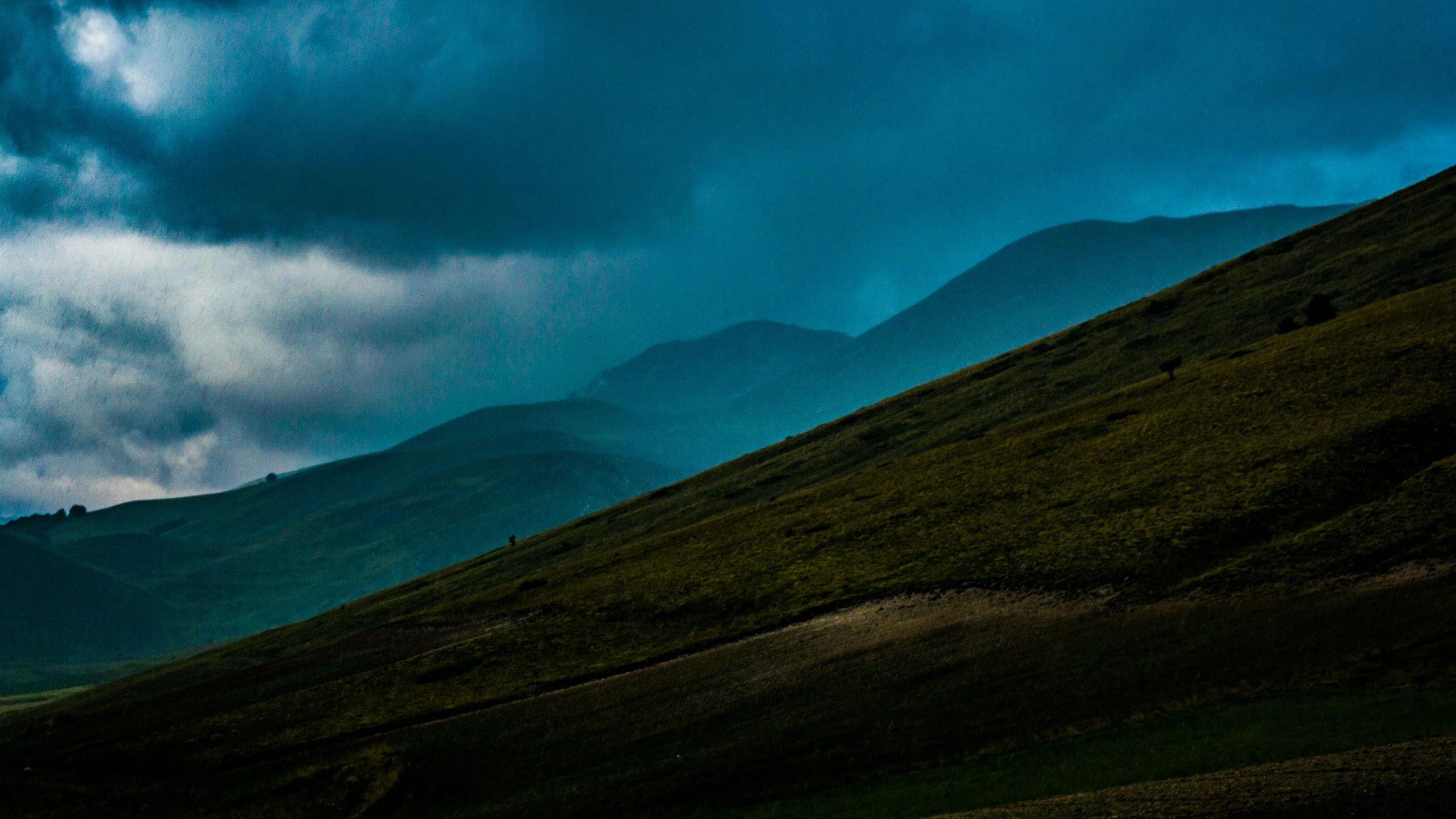 a herd of sheep standing on top of a lush green hillside, a matte painting, by Adam Marczyński, pexels contest winner, dark ominous mood, blue and green, storm in the evening, highlands