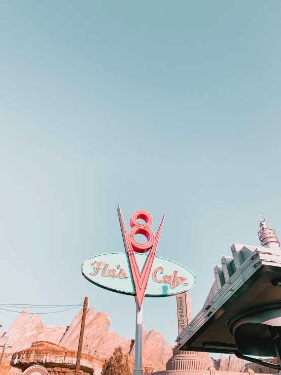 a couple of cars that are parked in front of a building, by Ryan Pancoast, pexels contest winner, retrofuturism, at california adventure, 🍸🍋, eight eight eight, old signs