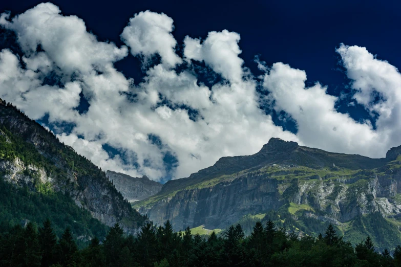 a view of a mountain with clouds in the sky, by Peter Churcher, pexels contest winner, figuration libre, lauterbrunnen valley, slide show, trees and cliffs, extra high resolution