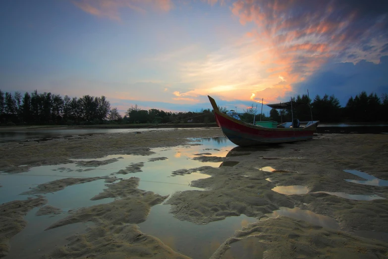 a boat sitting on top of a sandy beach, by Basuki Abdullah, unsplash contest winner, hurufiyya, end of day, nezha, shallow water, south east asian with long