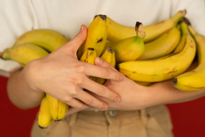 a person holding a bunch of bananas in their hands, an album cover, by Nina Hamnett, unsplash, 👅 👅, profile image, enormous hands, resin