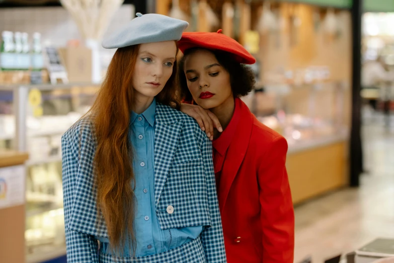 two women standing next to each other in a store, by Anita Malfatti, trending on pexels, renaissance, wearing a beret, azure and red tones, pale blue, fashion model