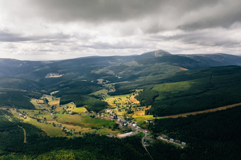 an aerial view of a small town in the mountains, pexels contest winner, hurufiyya, black forest, grey cloudy skies, victoria siemer, instagram photo