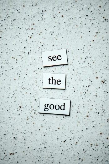 a piece of paper with the words see the good written on it, a picture, by Niko Henrichon, trending on unsplash, visual art, made of all white ceramic tiles, looking upwards, on grey background, kindness