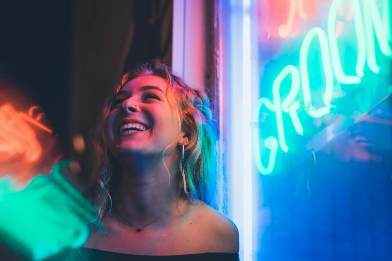 a woman laughing in front of a neon sign, pexels contest winner, attractive girl, josh grover, glowing windows, instagram post