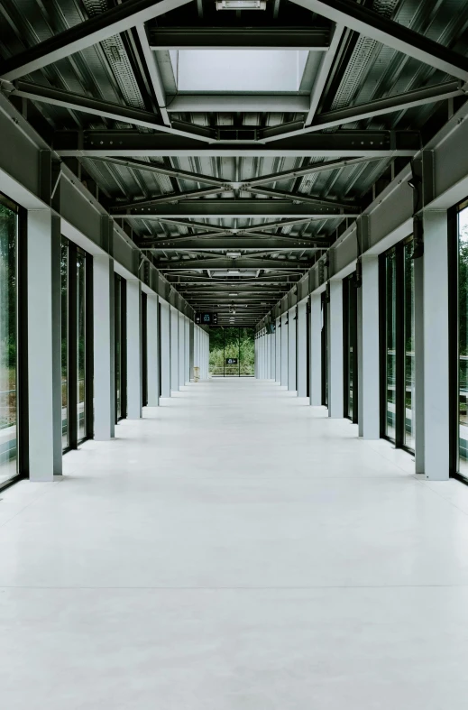 a long walkway in a building with lots of windows, by David Chipperfield, white steel, data center, full-shot, environmental shot