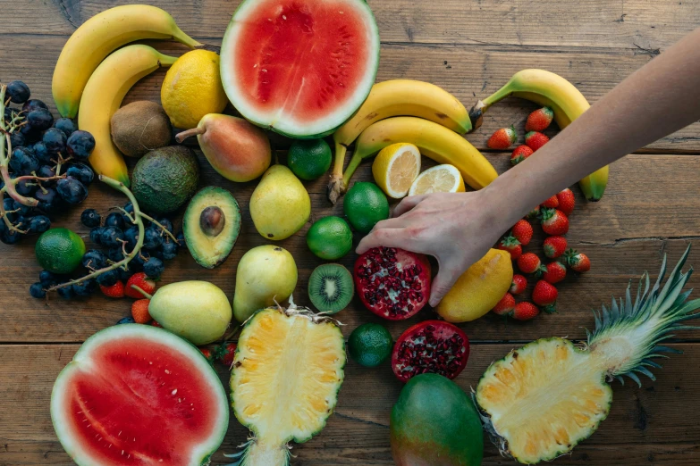 a bunch of fruit sitting on top of a wooden table, by Niko Henrichon, pexels, hands on counter, 🦩🪐🐞👩🏻🦳, multicoloured, william open